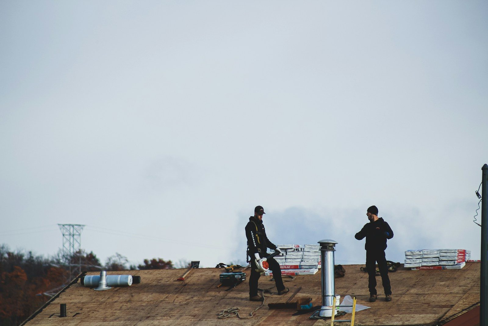Best Roof Inspections in Raleigh: a couple of men standing on top of a roof